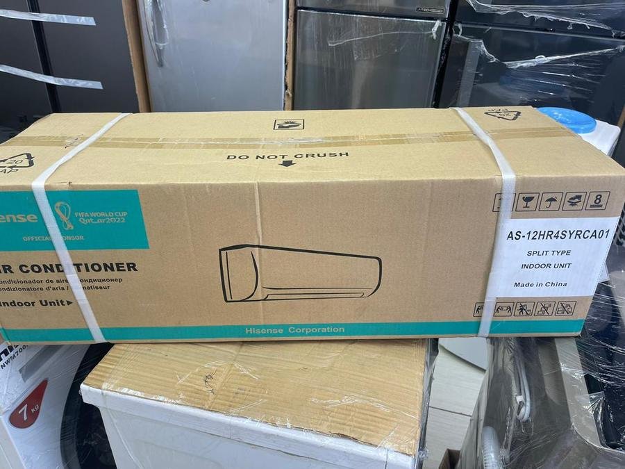 A Hisense 12,000 BTU indoor air conditioning unit held by LAMM Investment.